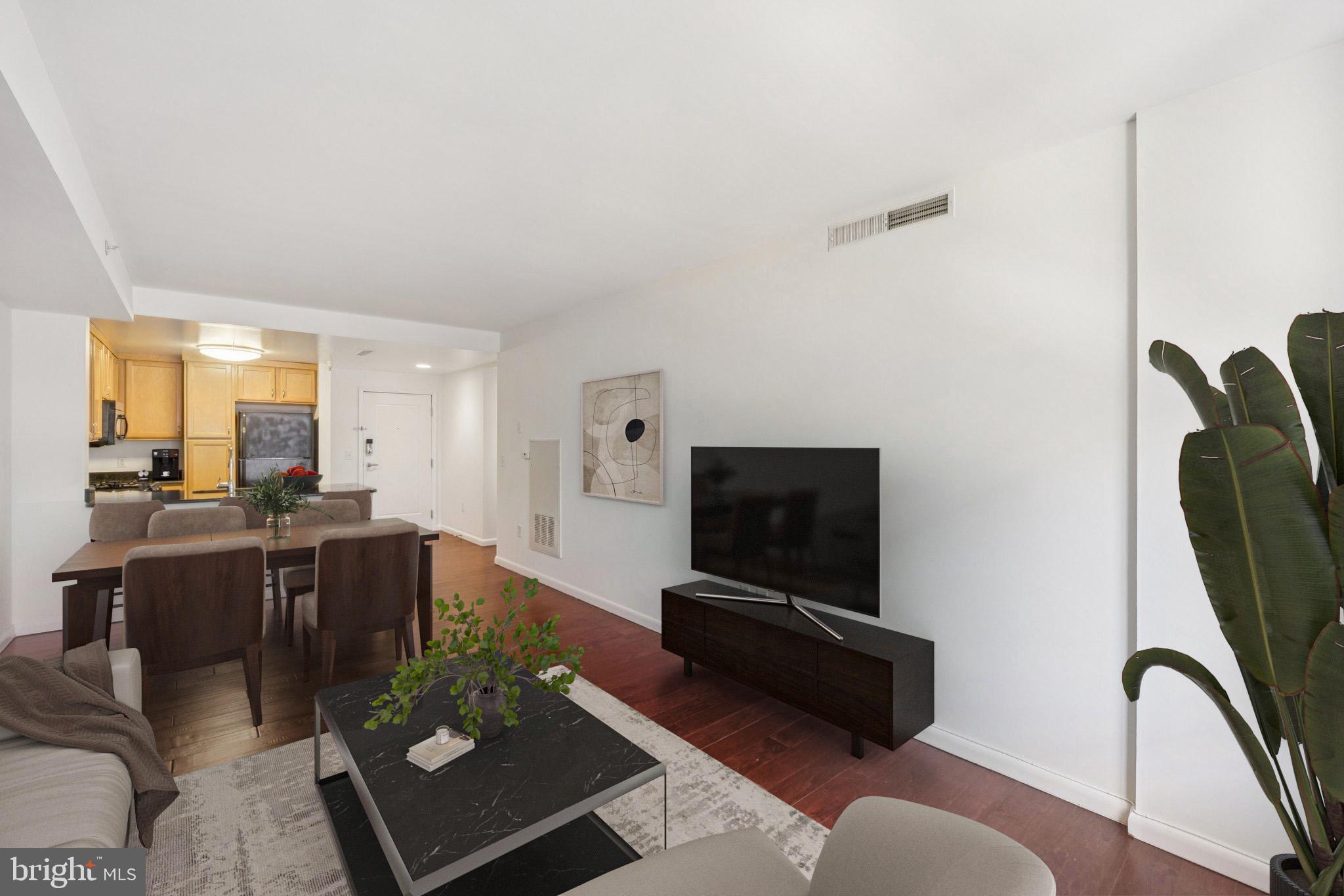355 I Street Southwest, Unit 410 Washington, DC 20024 - Photo 9 of 31 a living room with furniture and a flat screen tv