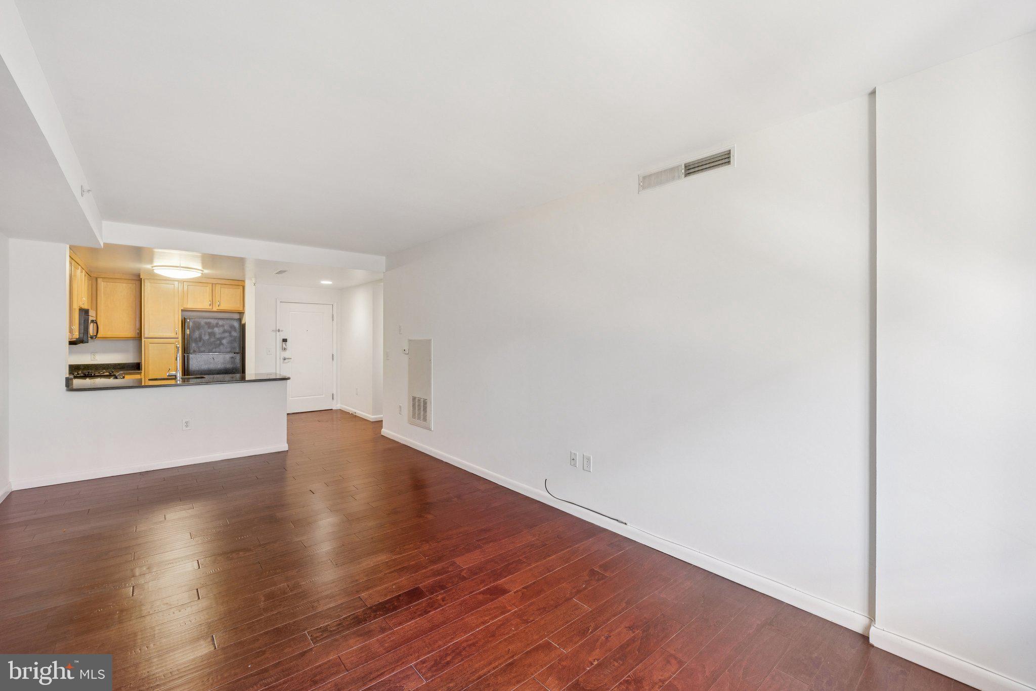 355 I Street Southwest, Unit 410 Washington, DC 20024 - Photo 10 of 31 a view of an empty room with wooden floor and a window