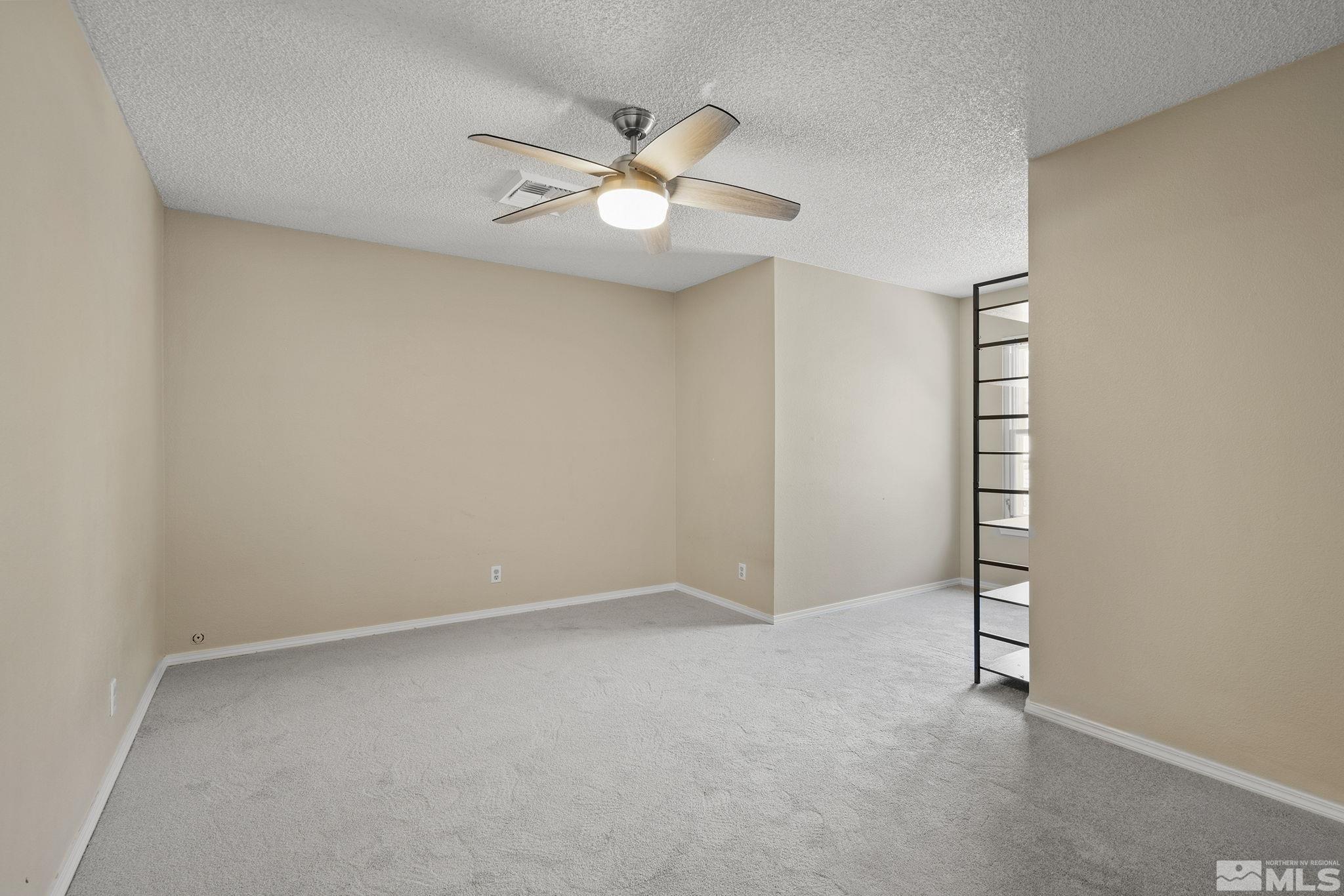 10055 Raintree Court Reno, NV 89511 - Photo 29 of 39 an empty room with windows and fan