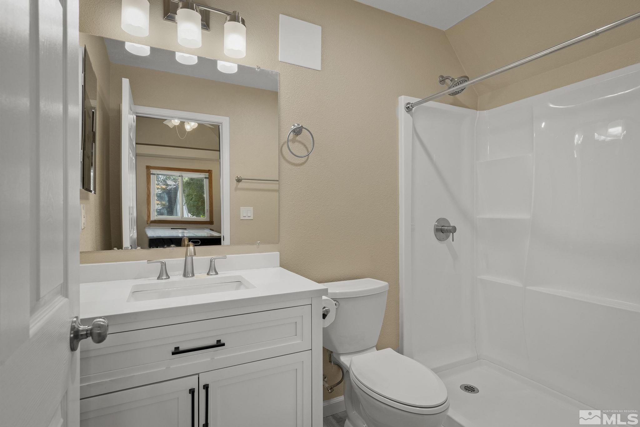 10055 Raintree Court Reno, NV 89511 - Photo 30 of 39 a bathroom with a sink a toilet a mirror and shower