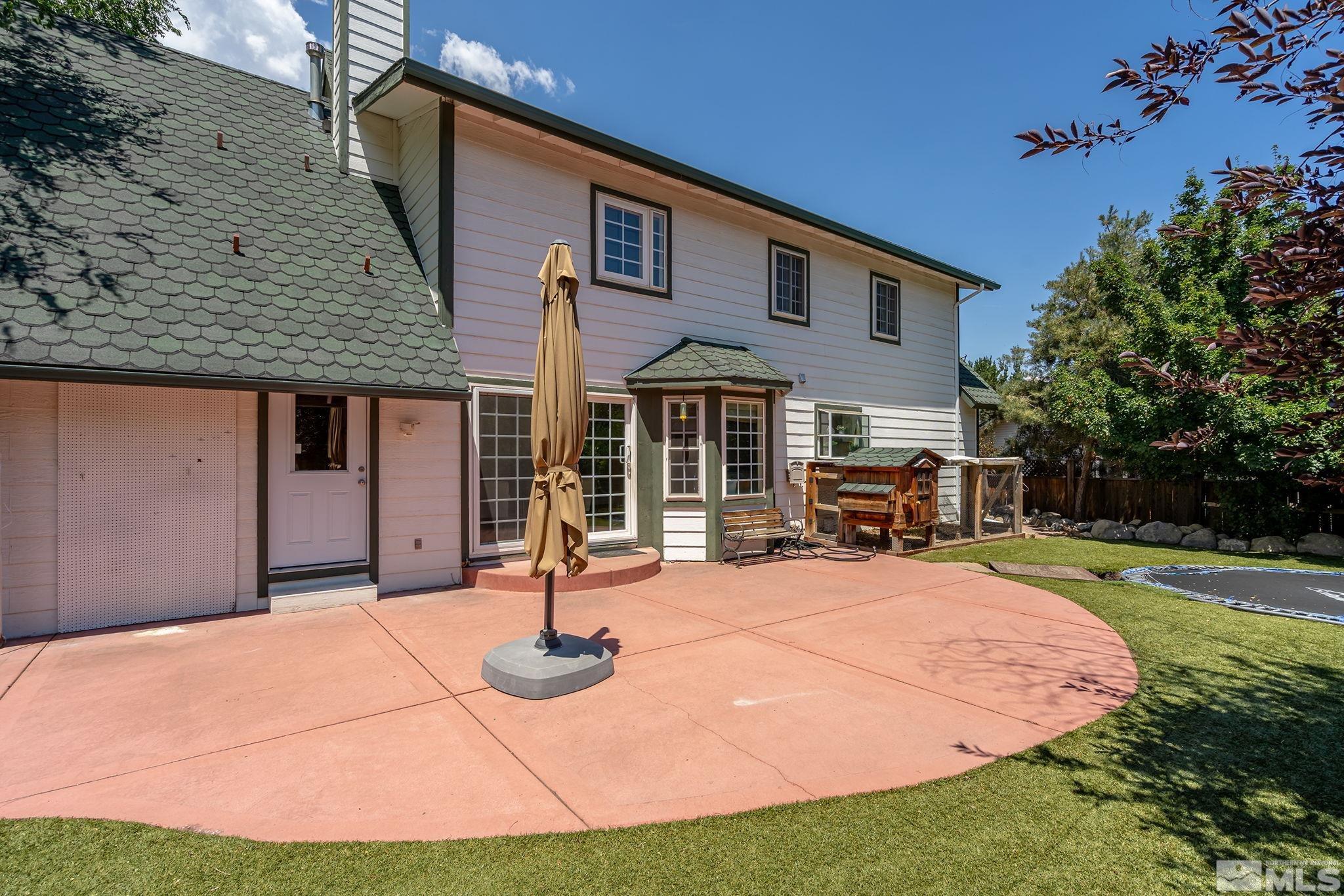 10055 Raintree Court Reno, NV 89511 - Photo 34 of 39 a front view of a house with yard patio and fire pit