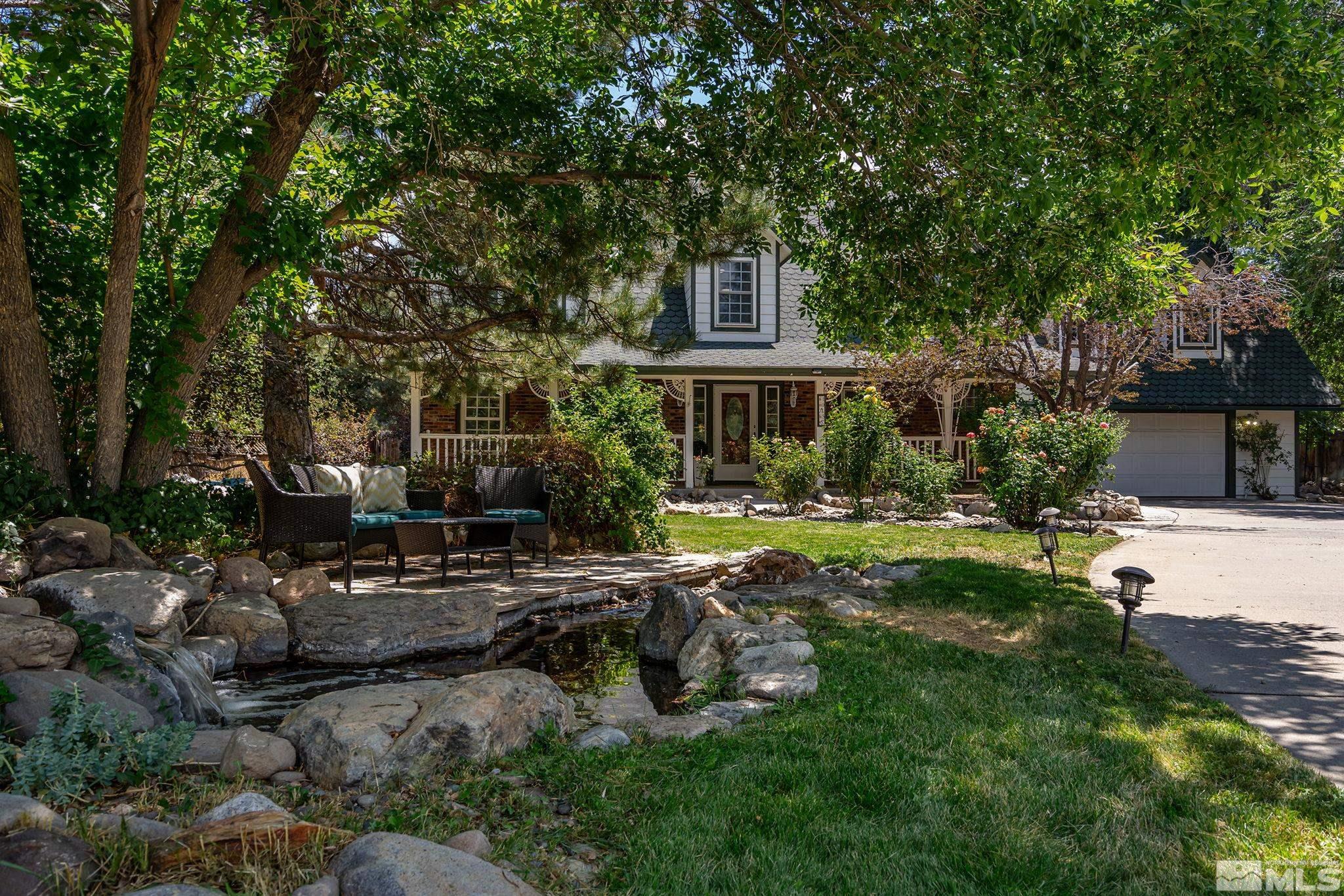 10055 Raintree Court Reno, NV 89511 - Photo 6 of 39 a view of a house with backyard sitting area and swimming pool