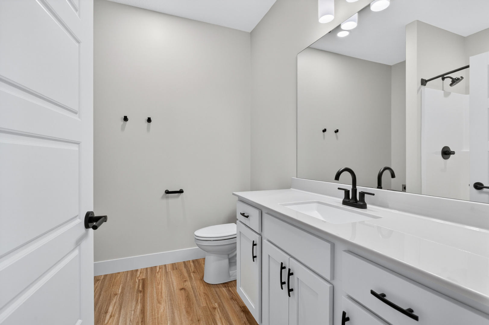 412 North 2nd Street Eldridge, IA 52748 - Photo 25 of 30 a bathroom with a granite countertop sink toilet and a mirror