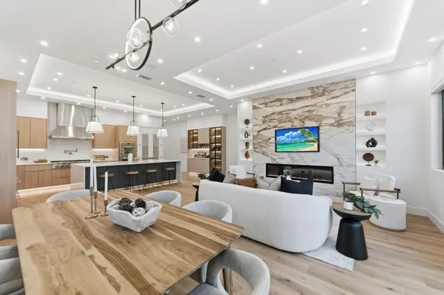 a view of a dining room with furniture large windows and wooden floor