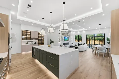 a kitchen with stainless steel appliances a sink stove and cabinets