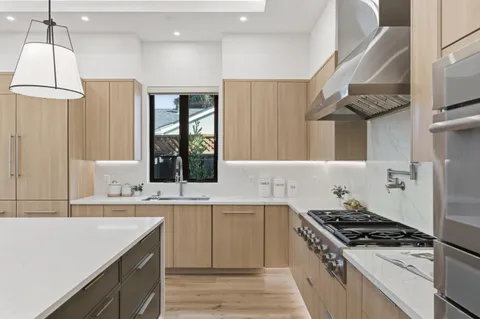 a large kitchen with a center island and stainless steel appliances