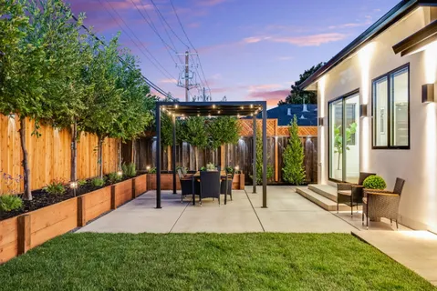 a man walking down a street next to a building
