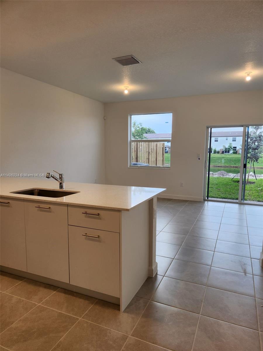 Miami-Dade County Miami, FL 33167 - Photo 11 of 18 a kitchen with a cabinets and a sink