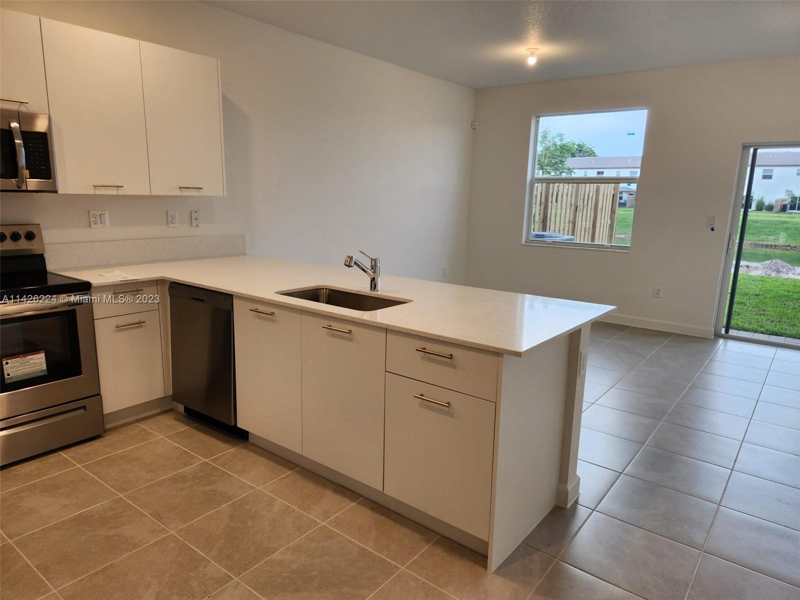 Miami-Dade County Miami, FL 33167 - Photo 12 of 18 a kitchen with a sink cabinets and window