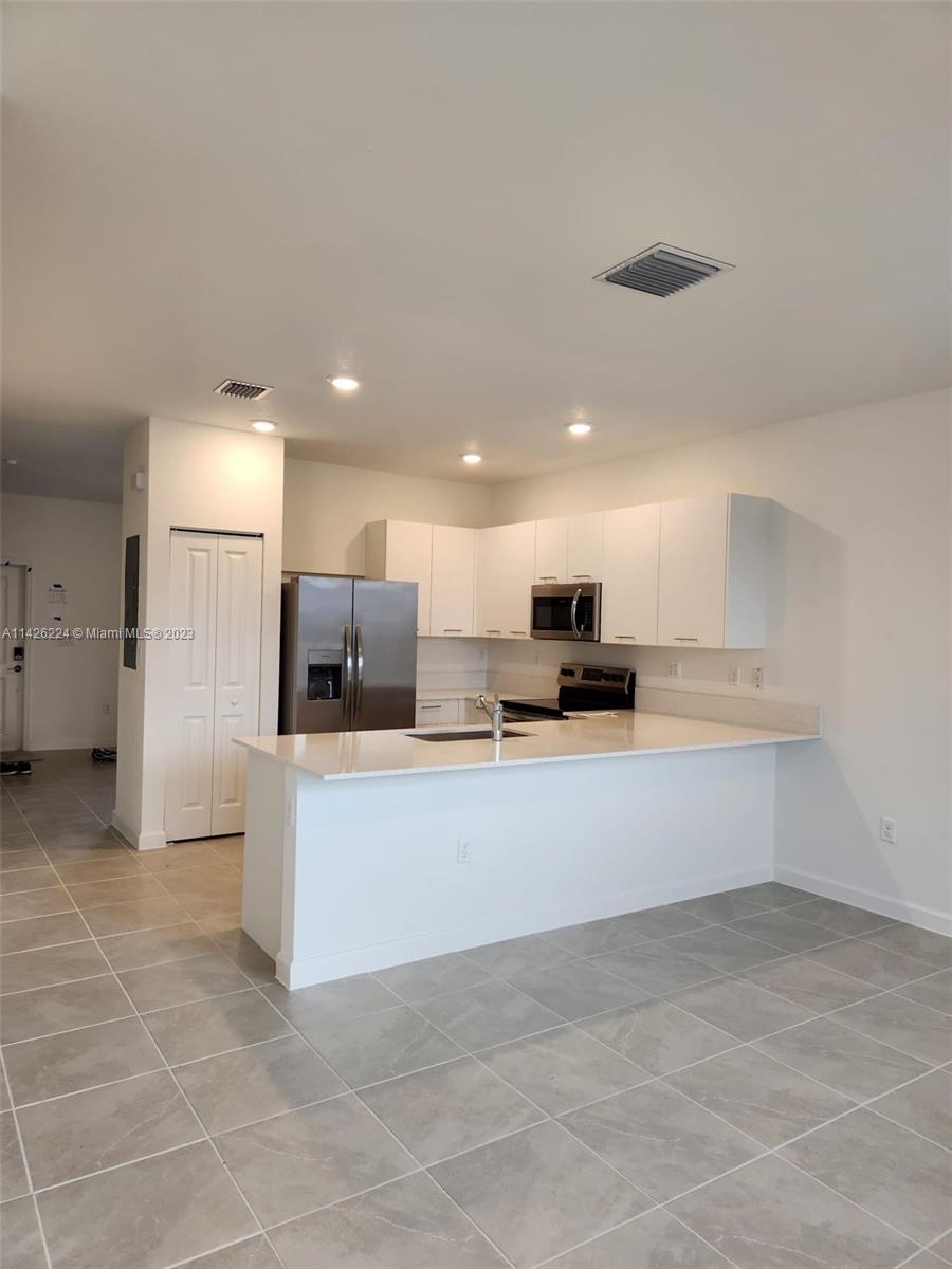 Miami-Dade County Miami, FL 33167 - Photo 3 of 18 a view of kitchen with stainless steel appliances kitchen island sink and refrigerator