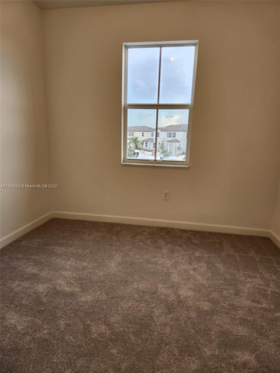 Miami-Dade County Miami, FL 33167 - Photo 10 of 18 an empty room with a window