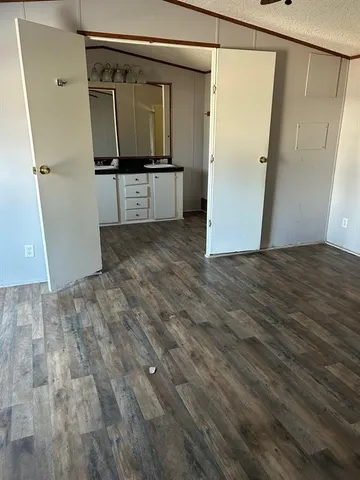 a view of a refrigerator in kitchen and wooden floor