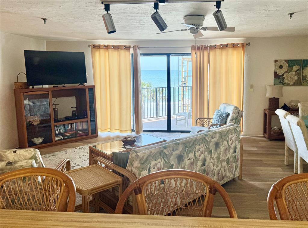 16330 Gulf Boulevard, Unit 201 Redington Beach, FL 33708 - Photo 12 of 30 a living room with furniture and a flat screen tv