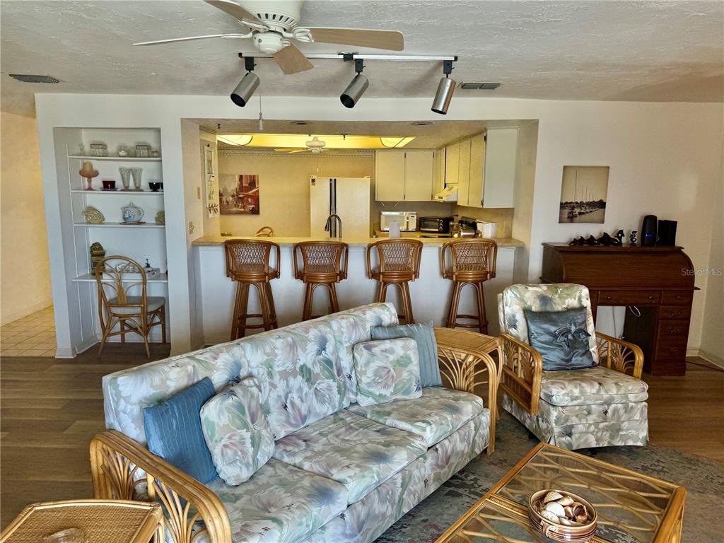 16330 Gulf Boulevard, Unit 201 Redington Beach, FL 33708 - Photo 15 of 30 a living room with furniture and a chandelier