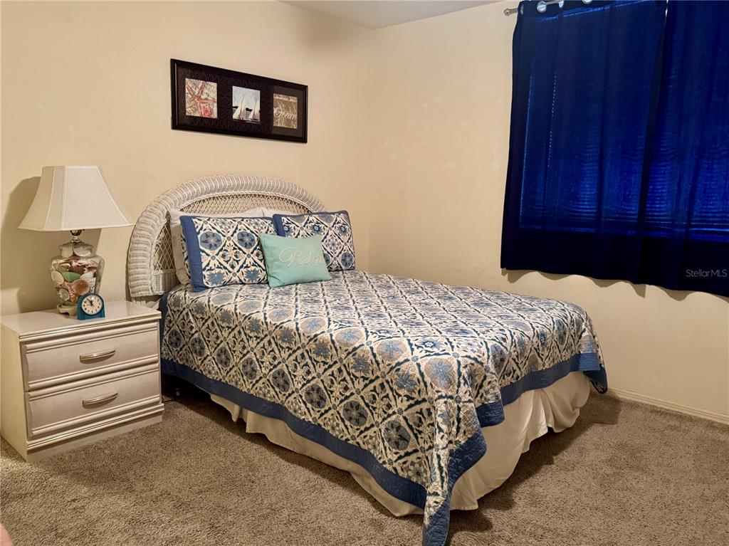 16330 Gulf Boulevard, Unit 201 Redington Beach, FL 33708 - Photo 2 of 30 a bedroom with a bed and painting on the wall