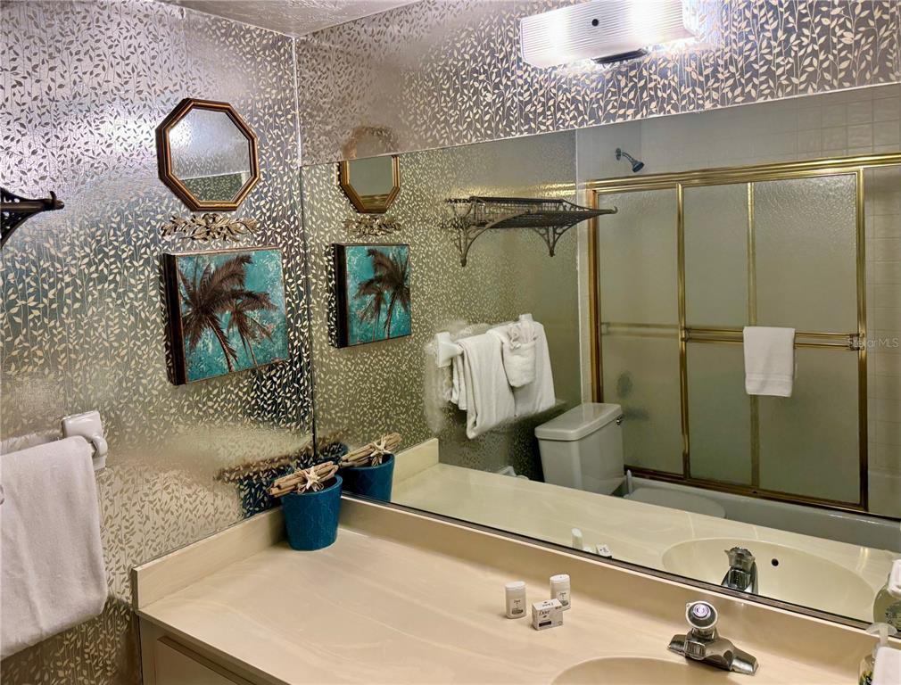 16330 Gulf Boulevard, Unit 201 Redington Beach, FL 33708 - Photo 4 of 30 a bathroom with a sink and mirror with toilet