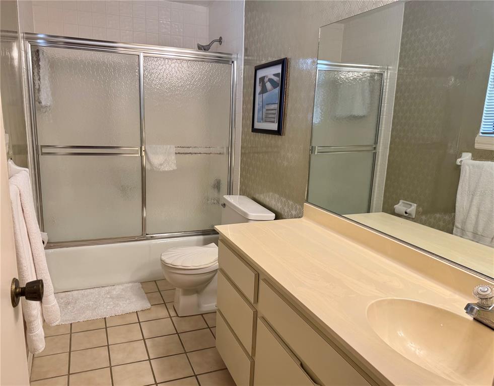 16330 Gulf Boulevard, Unit 201 Redington Beach, FL 33708 - Photo 8 of 30 a bathroom with a granite countertop sink toilet and shower