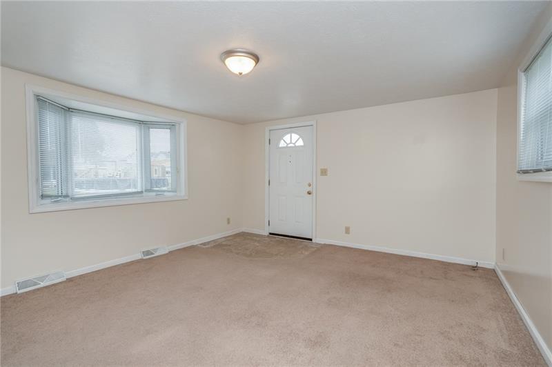 556 East Madison Street Rochester, PA 15074 - Photo 17 of 19 Spacious Living Room features bay window, wall-to-wall carpeting and fresh paint! Side door entry to offstreet parking is convenient.