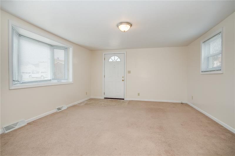 556 East Madison Street Rochester, PA 15074 - Photo 5 of 19 Spacious Living Room features bay window, wall-to-wall carpeting and fresh paint! Side door entry to offstreet parking is convenient.