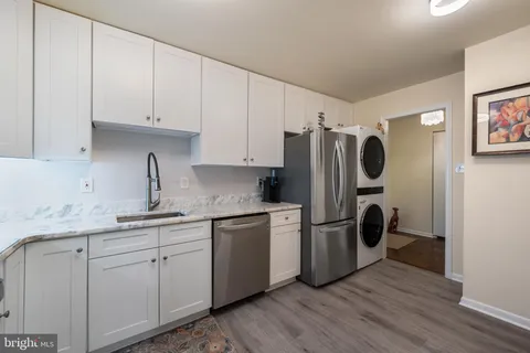a kitchen with stainless steel appliances a refrigerator sink and cabinets