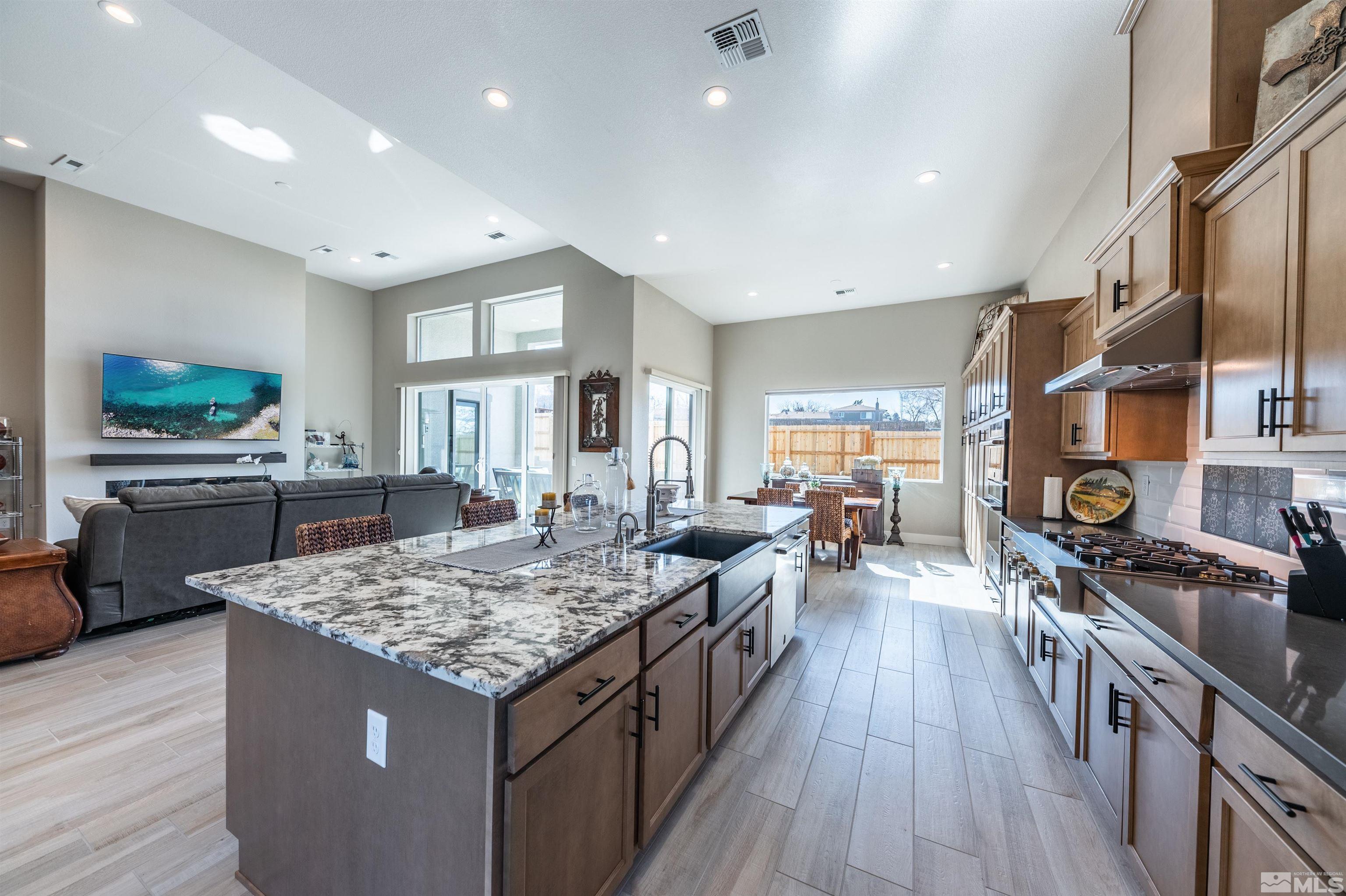 2962 Saddle Peak Drive Reno, NV 89521 - Photo 12 of 39 a large kitchen with lots of counter space and wooden floor