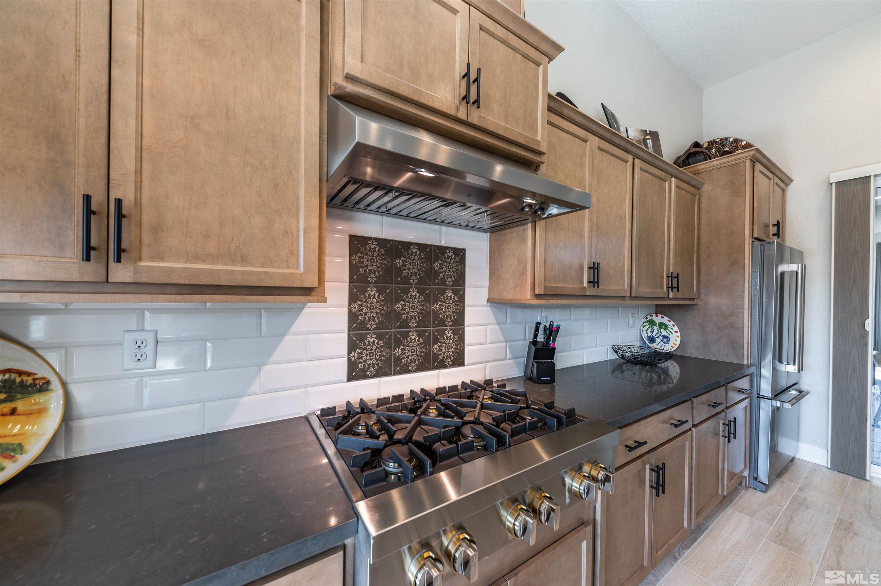 2962 Saddle Peak Drive Reno, NV 89521 - Photo 16 of 39 a kitchen with stainless steel appliances granite countertop a sink stove and cabinets
