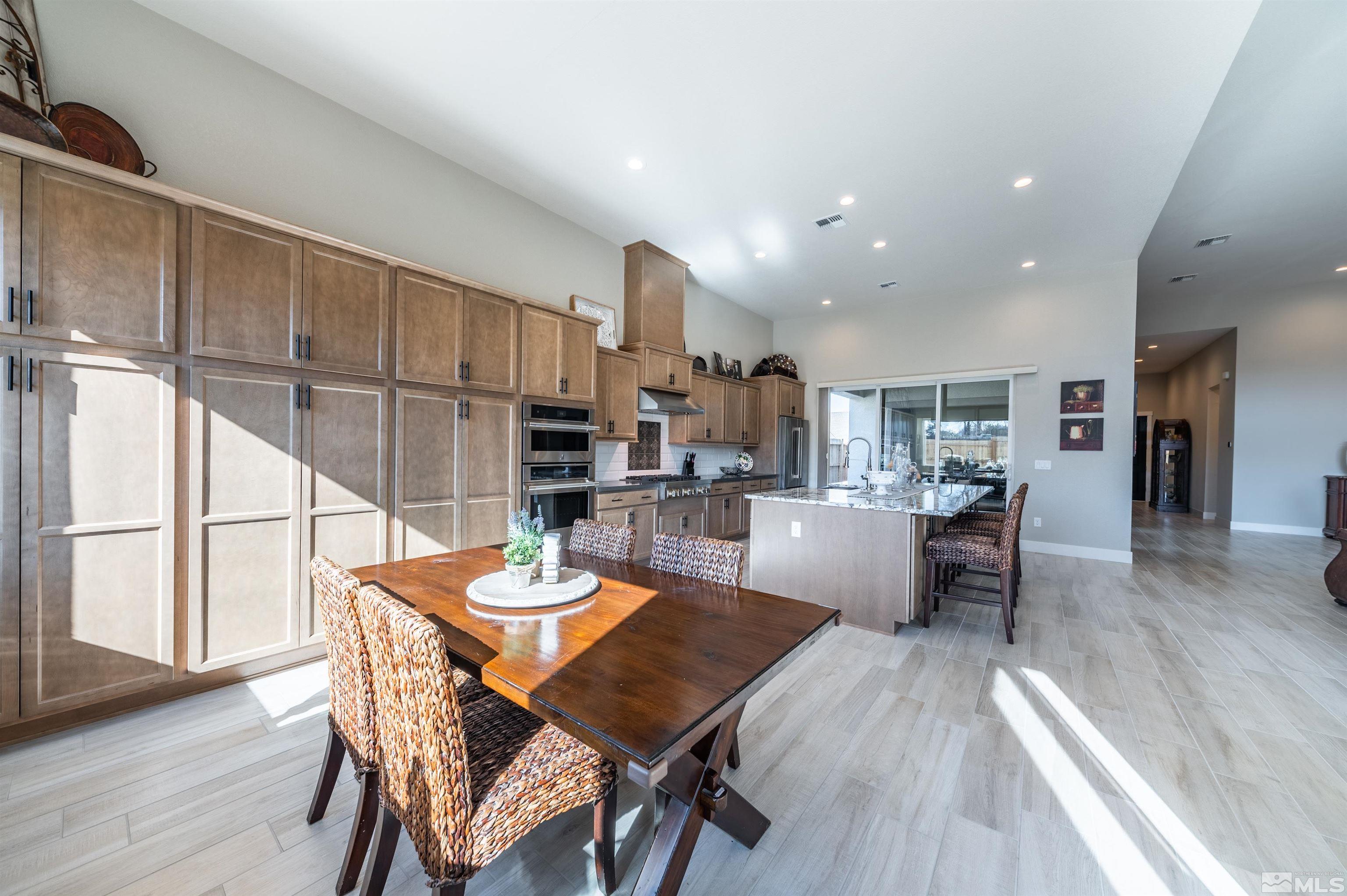 2962 Saddle Peak Drive Reno, NV 89521 - Photo 18 of 39 a view of a dining room with furniture and wooden floor