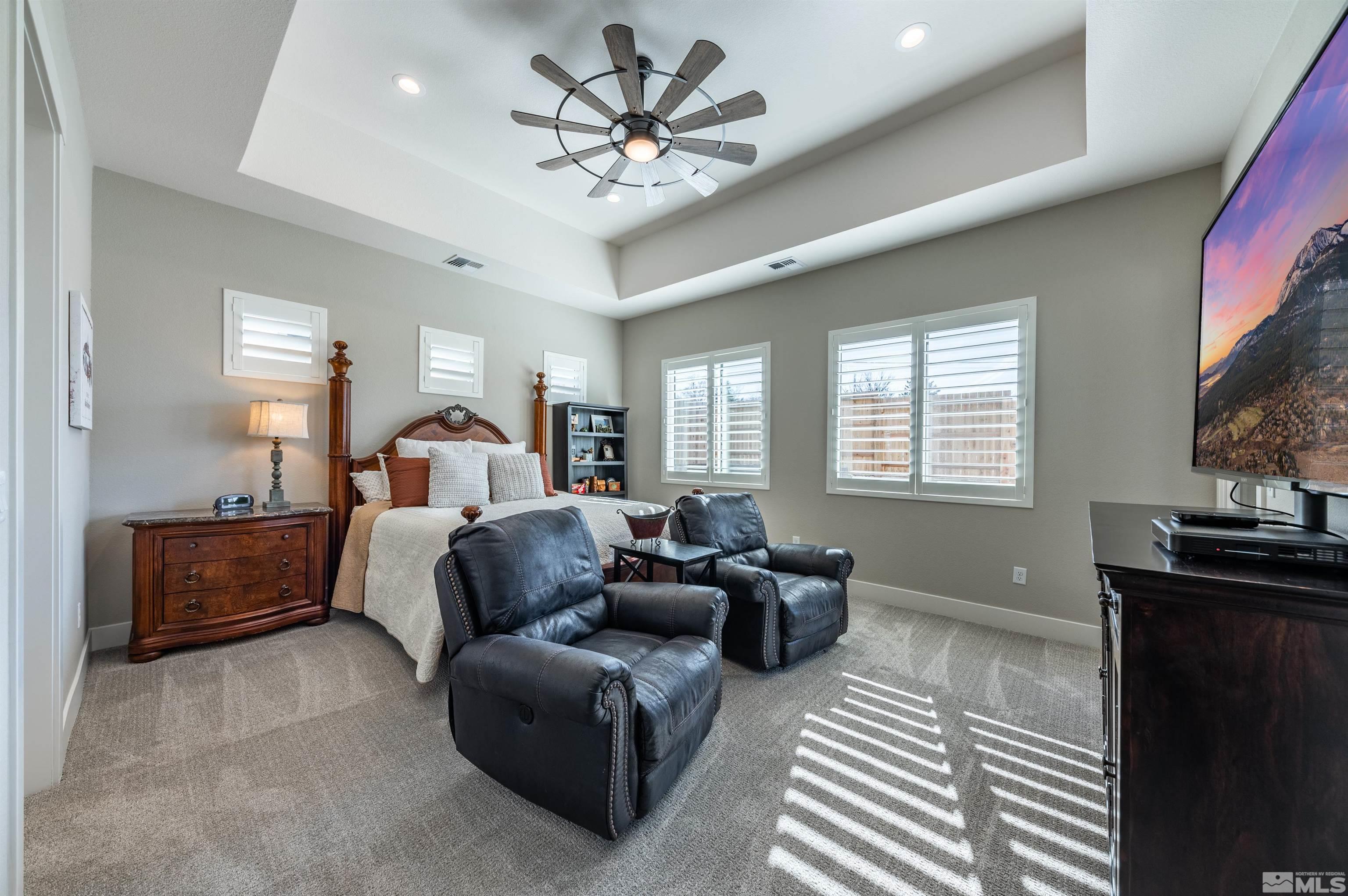 2962 Saddle Peak Drive Reno, NV 89521 - Photo 19 of 39 a living room with furniture a chandelier and a flat screen tv