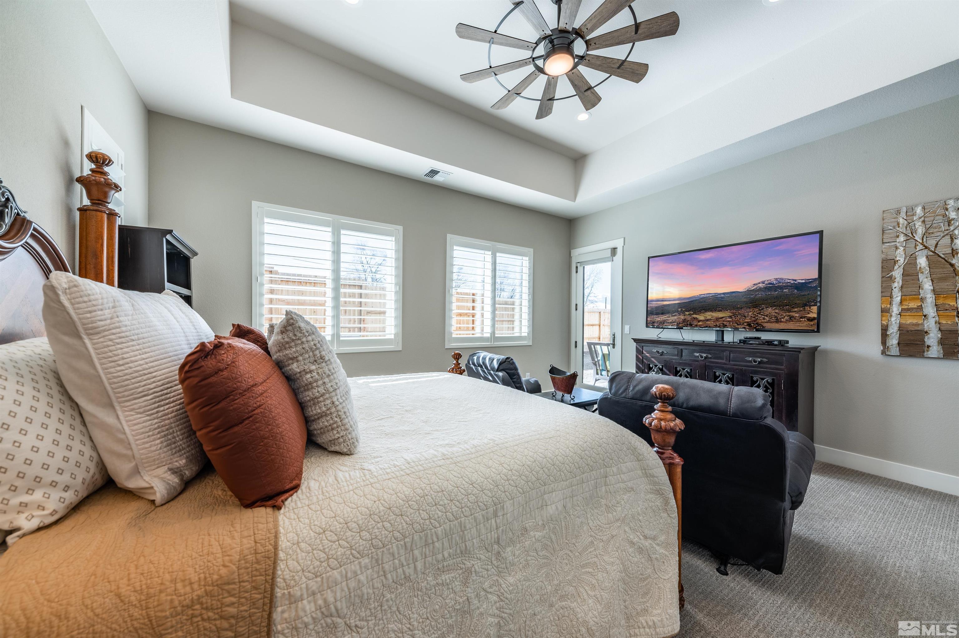 2962 Saddle Peak Drive Reno, NV 89521 - Photo 20 of 39 a bedroom with a bed couch tv and a window