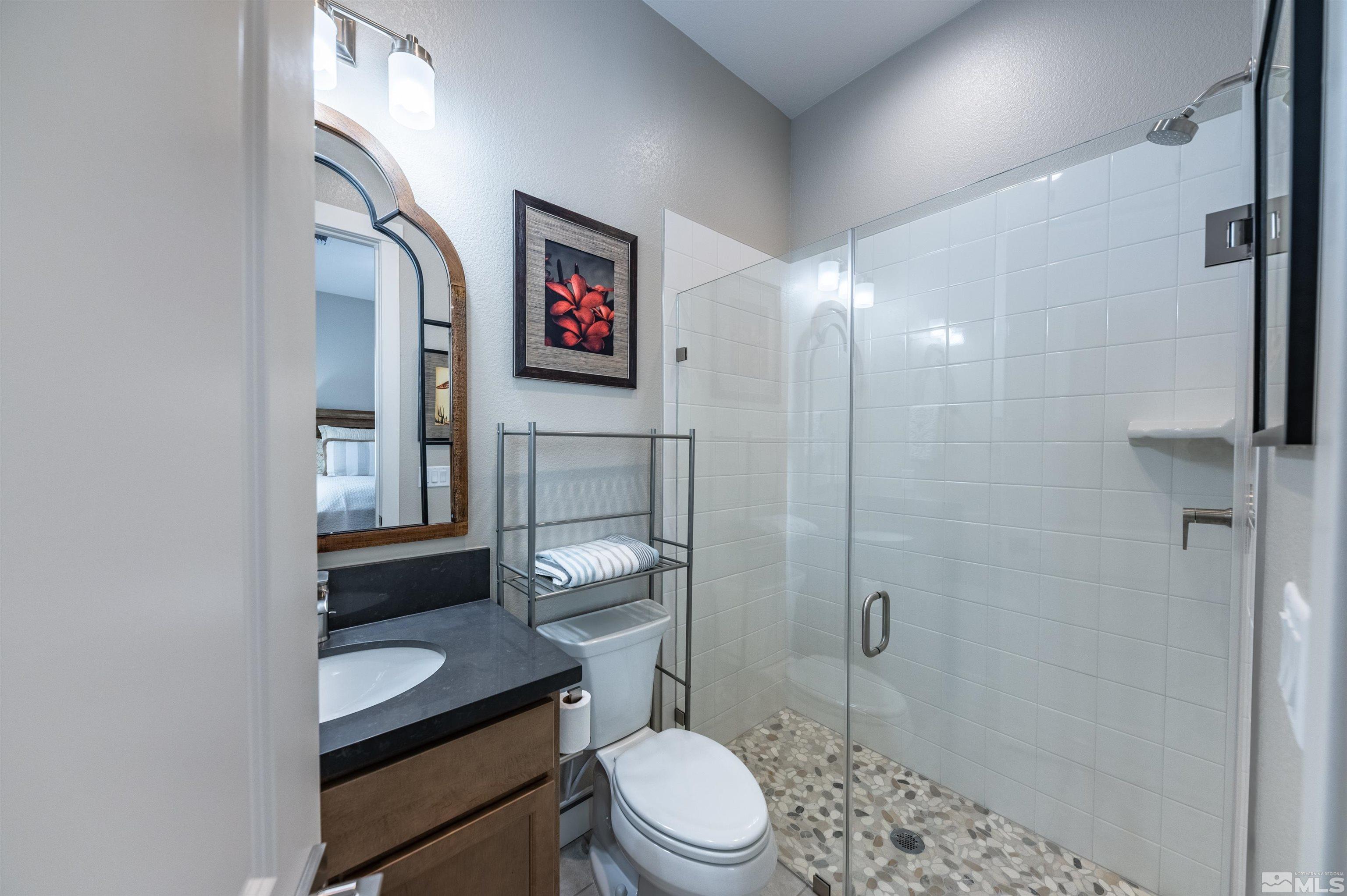 2962 Saddle Peak Drive Reno, NV 89521 - Photo 27 of 39 a bathroom with a toilet a sink and shower