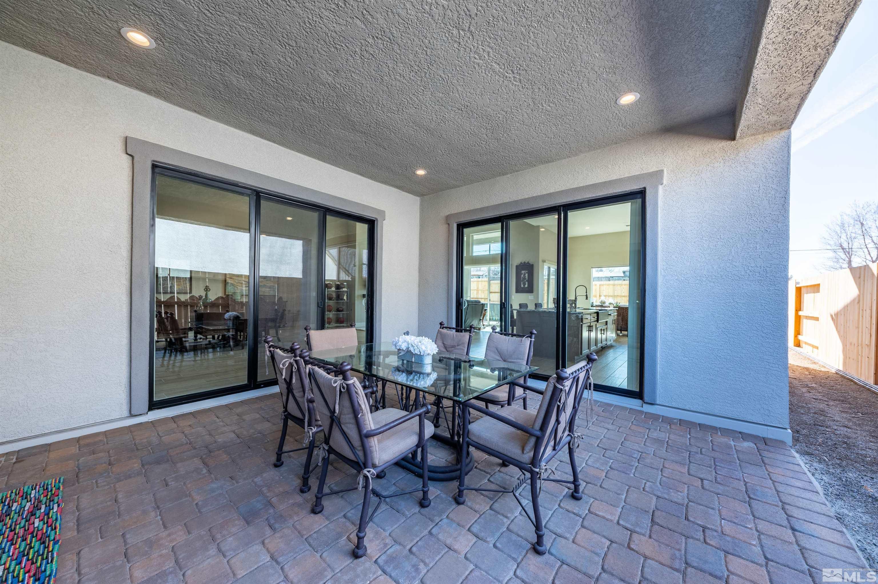 2962 Saddle Peak Drive Reno, NV 89521 - Photo 28 of 39 a view of a dining room with furniture and floor to ceiling windows