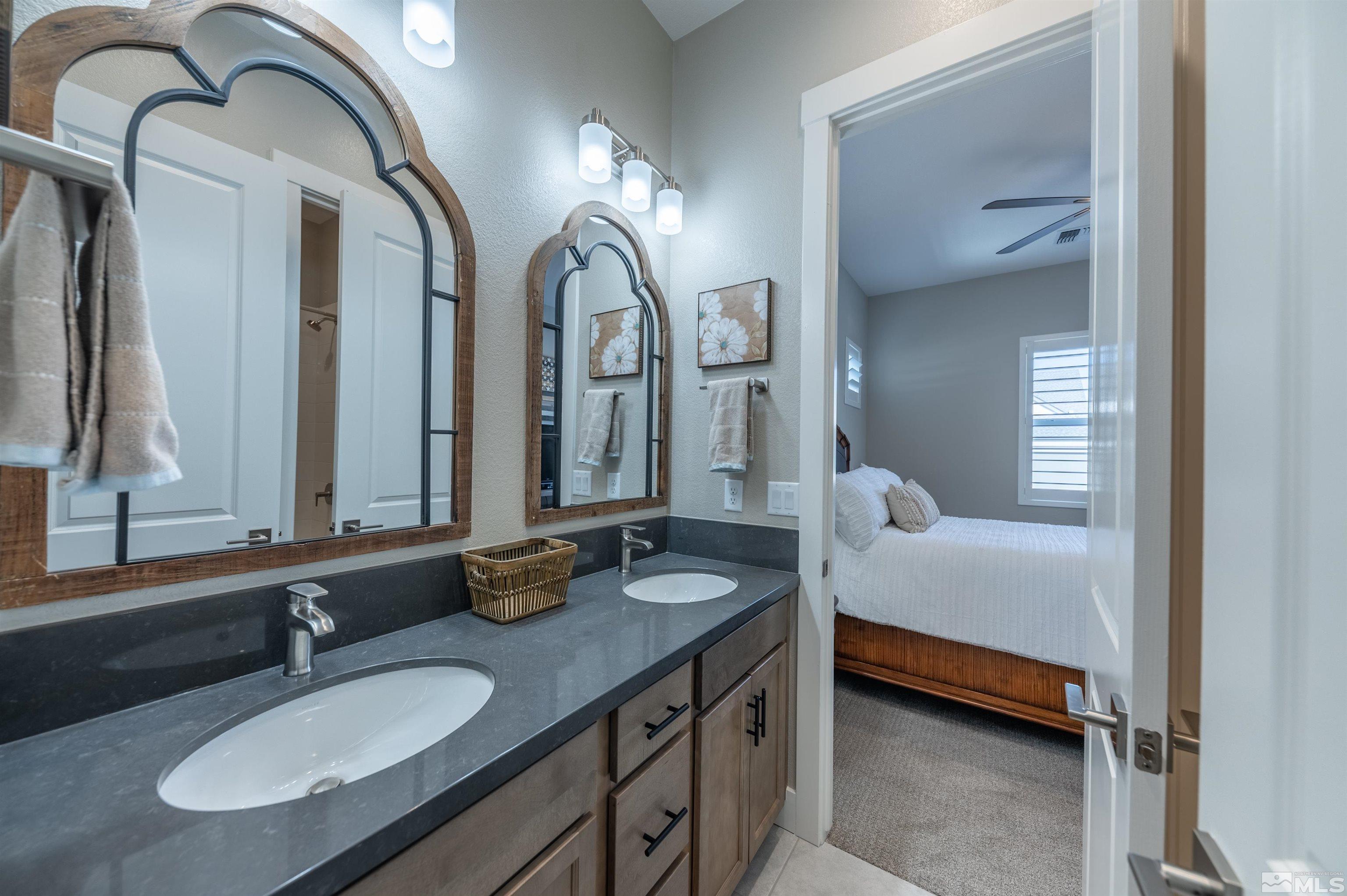 2962 Saddle Peak Drive Reno, NV 89521 - Photo 31 of 39 a en suite bathroom with double vanity sinks and a mirror