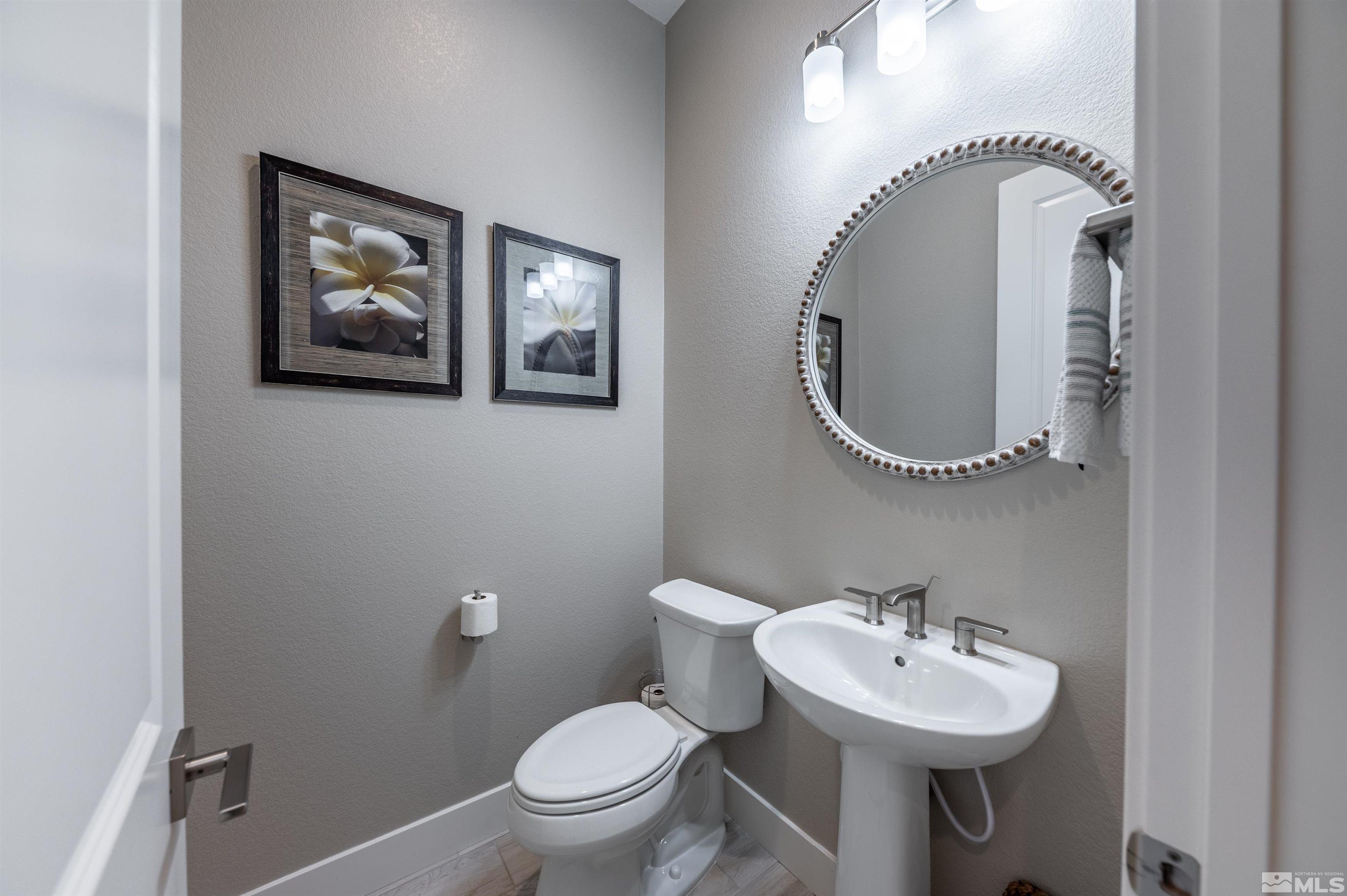 2962 Saddle Peak Drive Reno, NV 89521 - Photo 34 of 39 a bathroom with a toilet sink and mirror