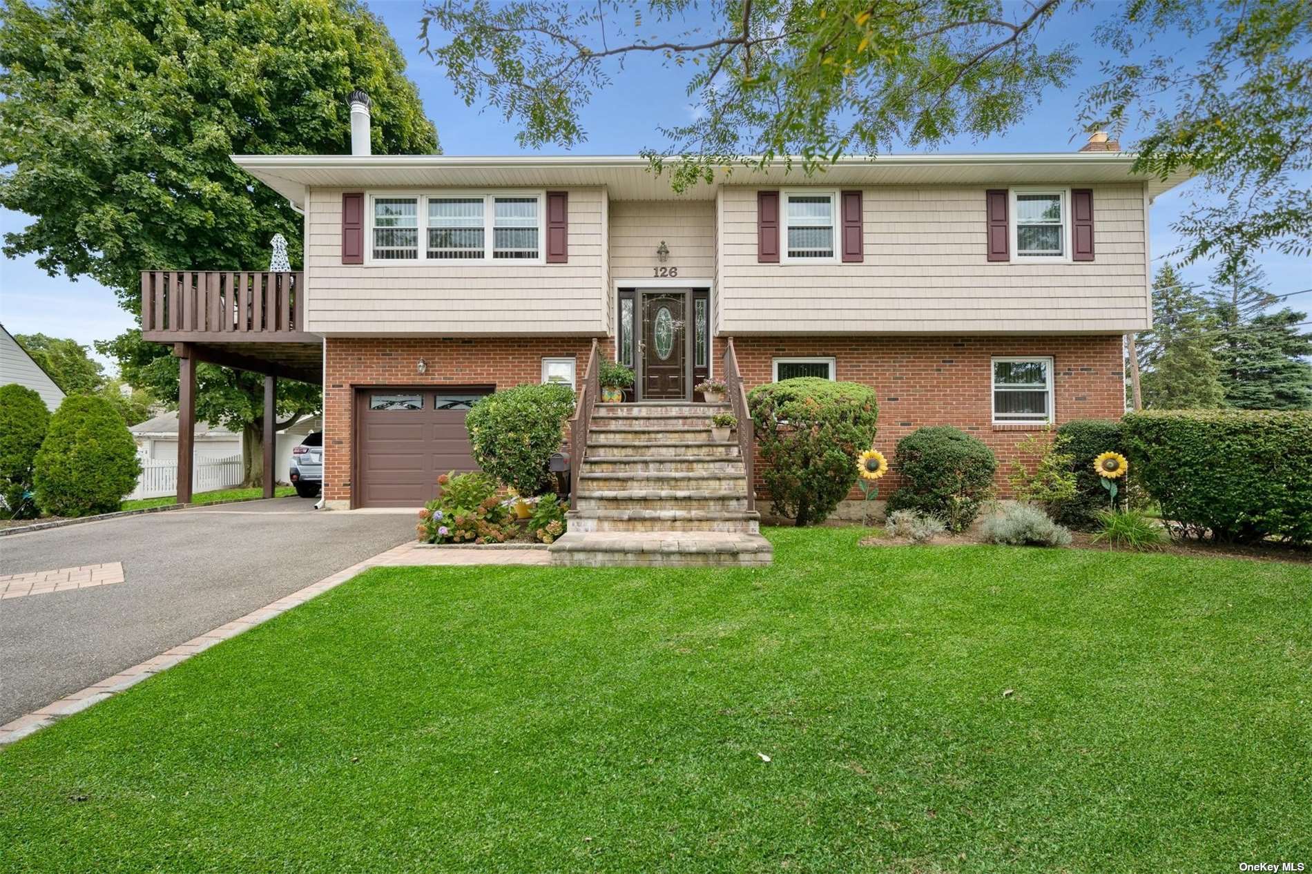 126 Broadway Bethpage, NY 11714 - Photo 1 of 1 a front view of a house with a garden