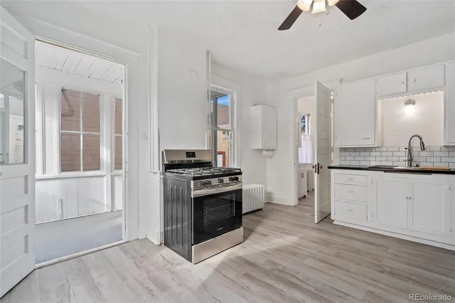 a kitchen with stainless steel appliances granite countertop a stove and a sink