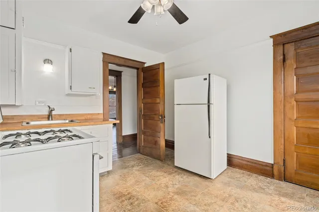 a view of kitchen with refrigerator and window