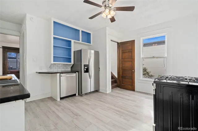 a kitchen with stainless steel appliances a stove a refrigerator and a refrigerator