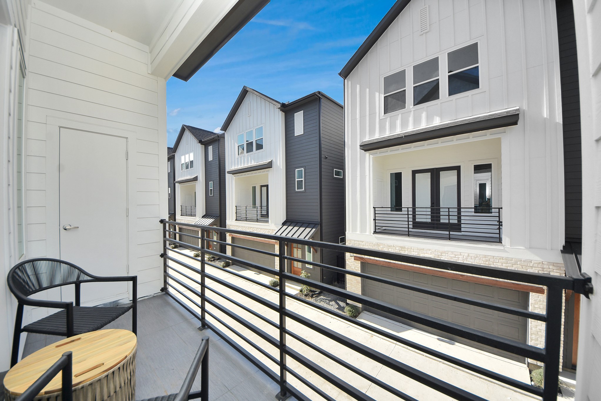 927 Fisher Street, Unit B Houston, TX 77018 - Photo 39 of 47 This cozy balcony offers a serene outdoor space with sleek railings, two chairs, and a small table—ideal for enjoying morning coffee or evening relaxation while taking in the neighborhood views.