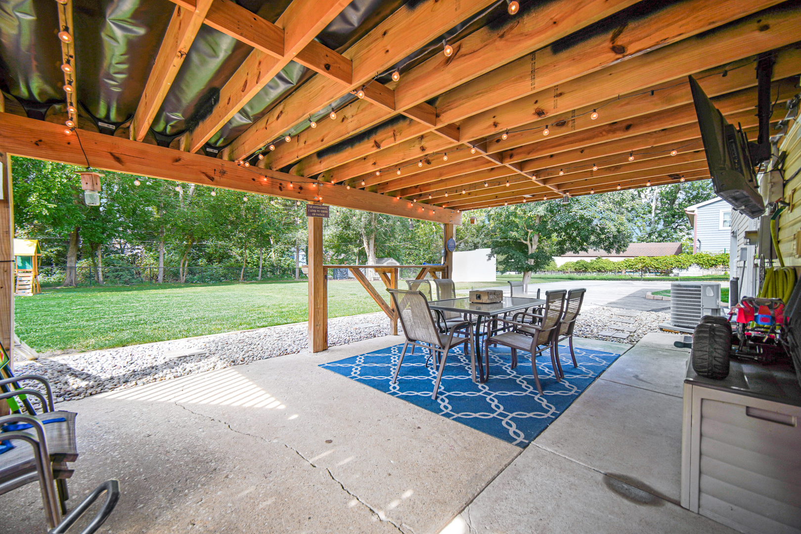 235 Roberts Road New Lenox, IL 60451 - Photo 23 of 25 a view of a patio with table and chairs and floor to ceiling window with wooden fence