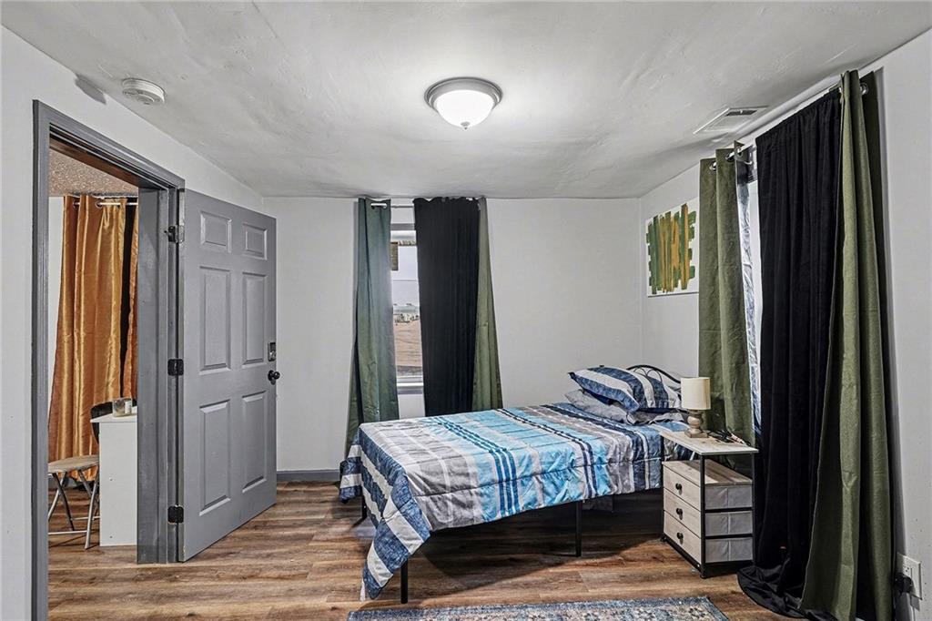 123 Brawner Street Griffin, GA 30223 - Photo 12 of 25 a bedroom with a bed and a mirror