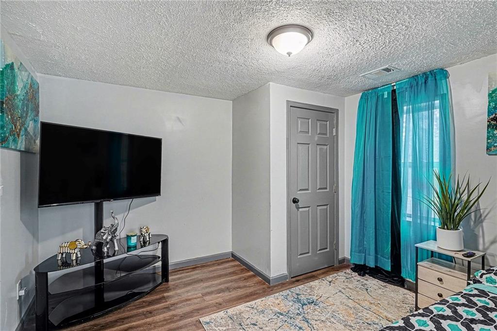123 Brawner Street Griffin, GA 30223 - Photo 18 of 25 a living room with furniture and a flat screen tv