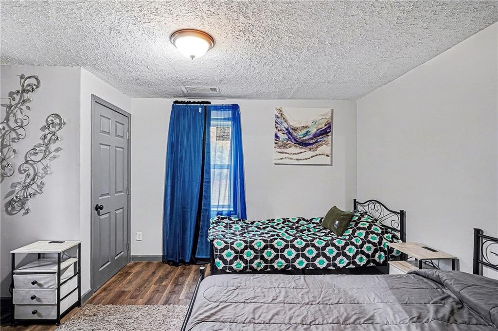 123 Brawner Street Griffin, GA 30223 - Photo 19 of 25 a bedroom with a bed and a dresser