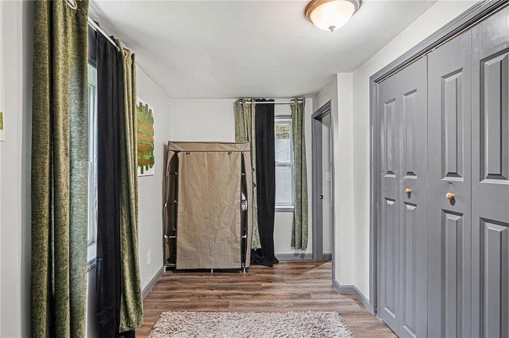 123 Brawner Street Griffin, GA 30223 - Photo 22 of 25 a view of a hallway with wooden floor and a cabinet