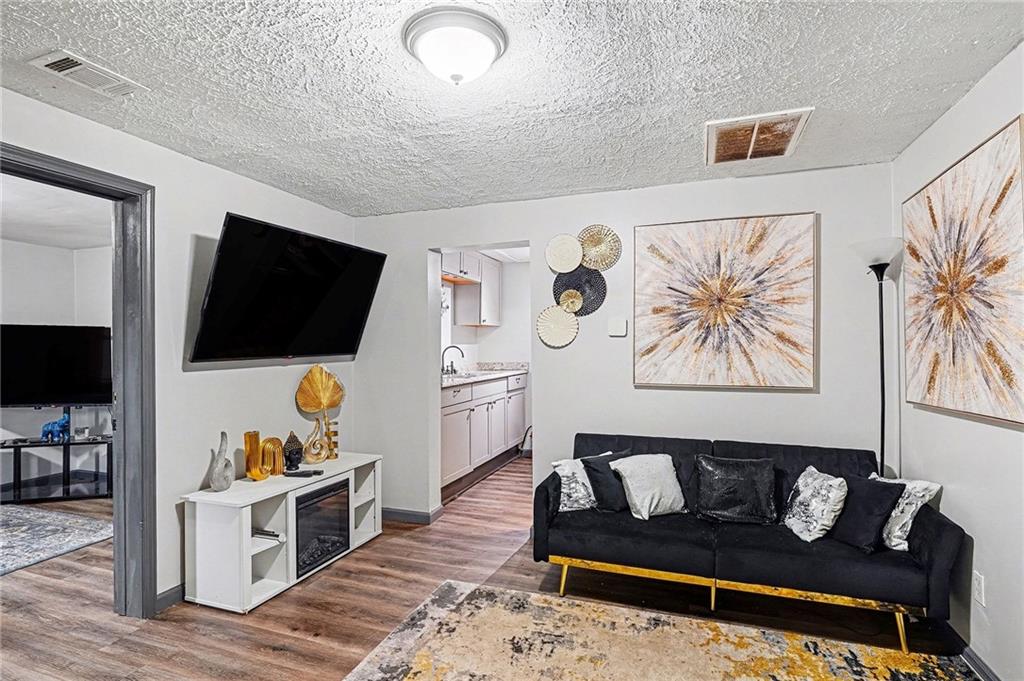 123 Brawner Street Griffin, GA 30223 - Photo 3 of 25 a living room with furniture and a flat screen tv