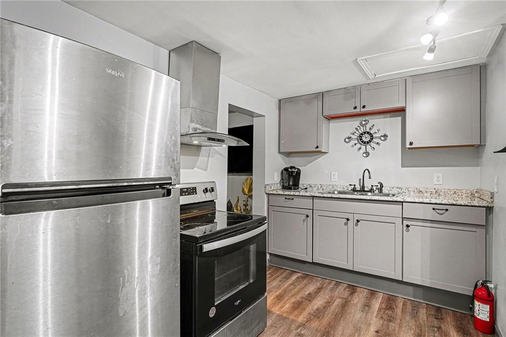 123 Brawner Street Griffin, GA 30223 - Photo 7 of 25 a kitchen with stainless steel appliances a refrigerator sink and cabinets