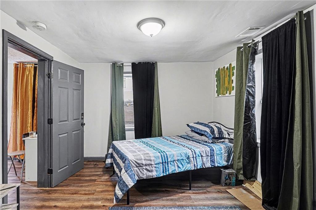 123 Brawner Street Griffin, GA 30223 - Photo 10 of 25 a bedroom with a bed and a mirror