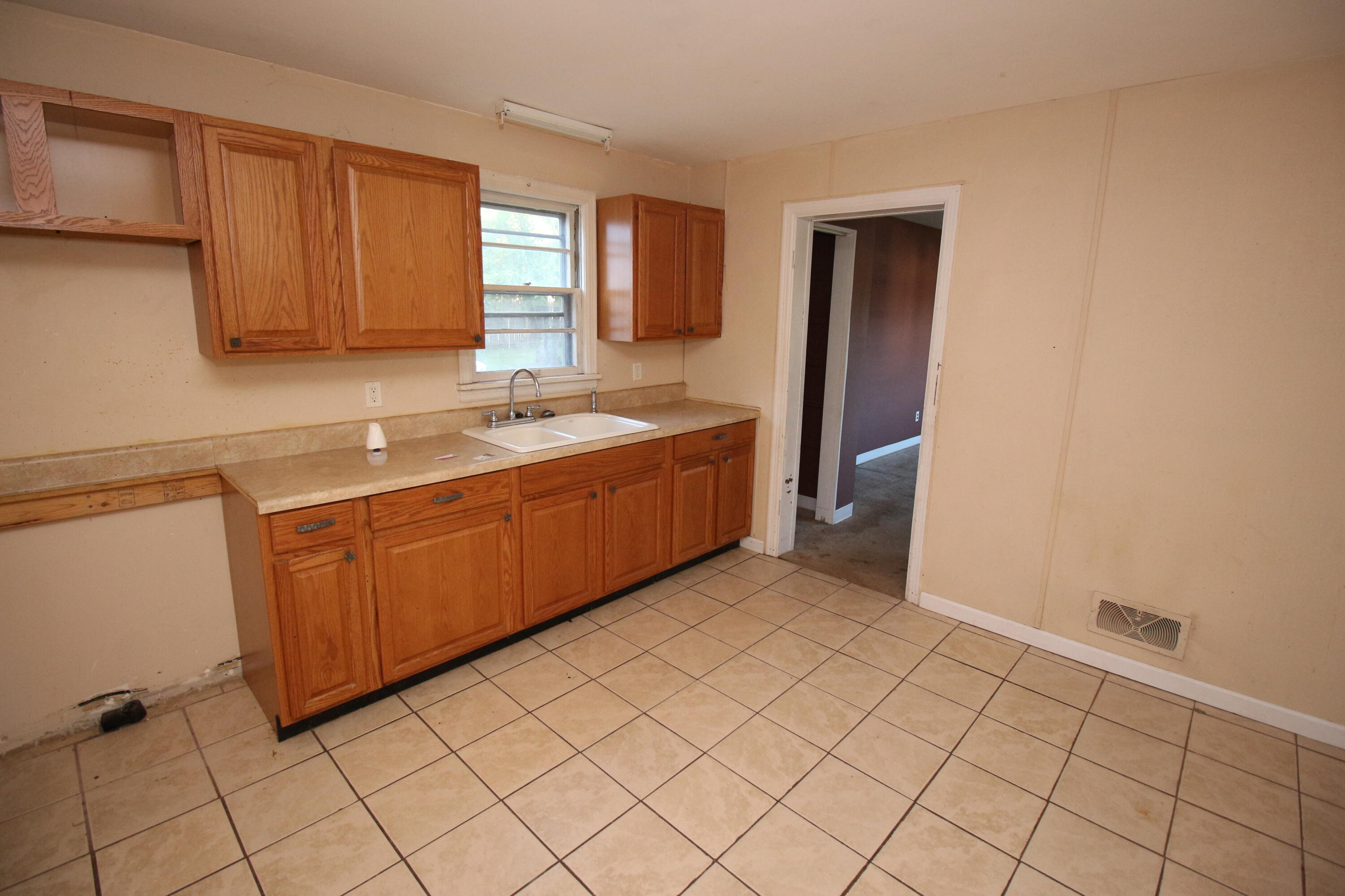 2205 Plantation Road Northeast Roanoke, VA 24012 - Photo 11 of 13 a view of a kitchen with white cabinets