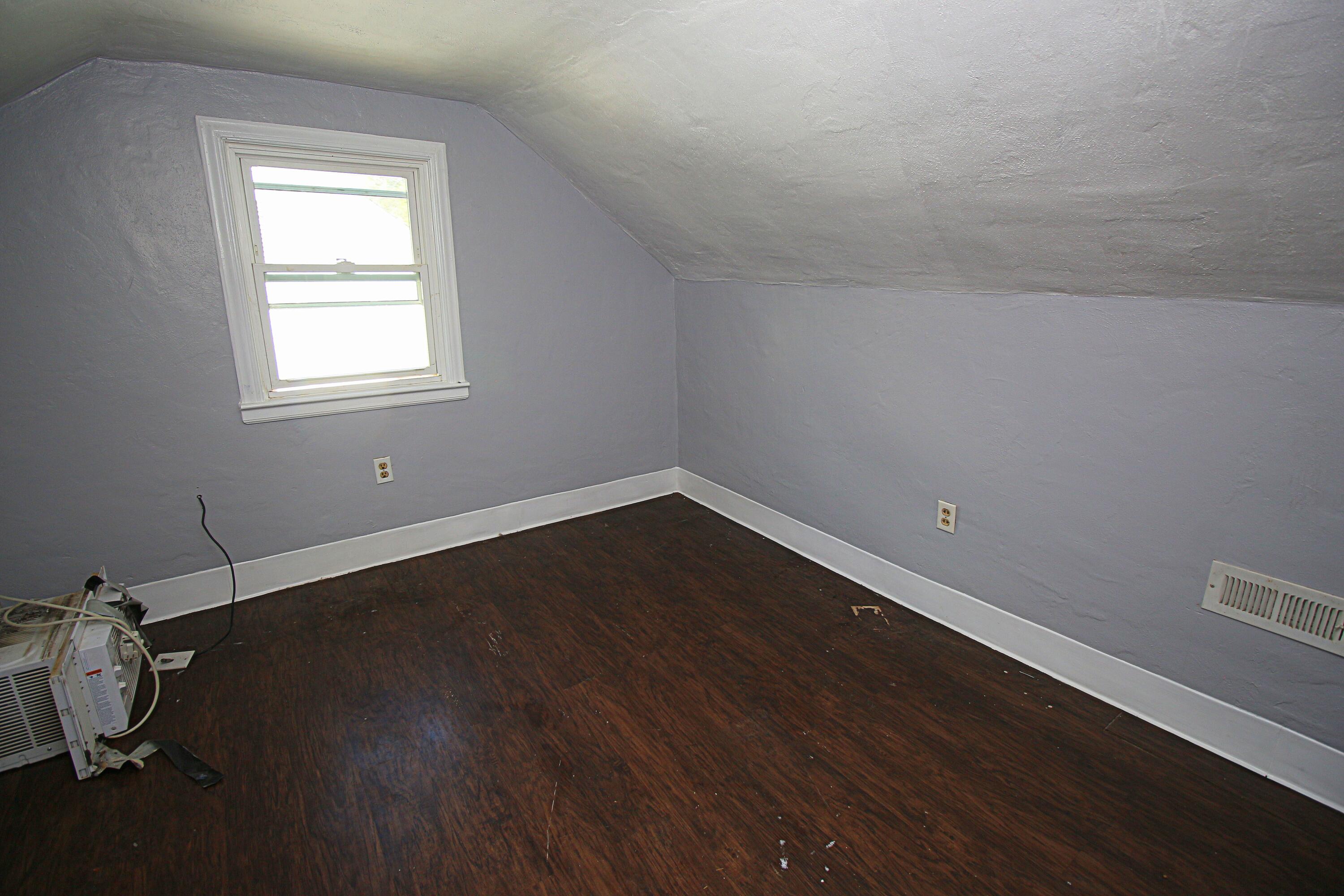2205 Plantation Road Northeast Roanoke, VA 24012 - Photo 13 of 13 an empty room with wooden floor and windows