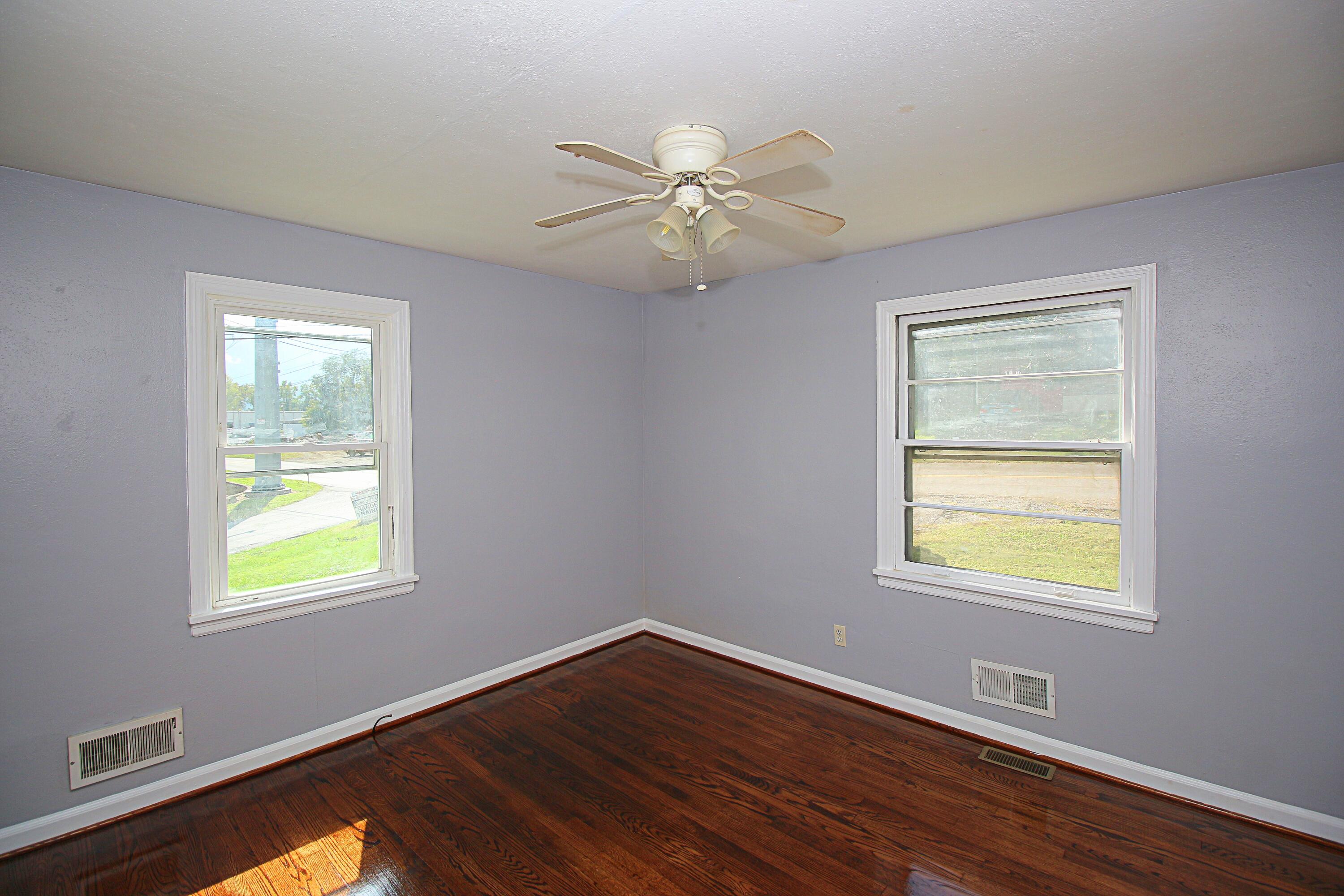 2205 Plantation Road Northeast Roanoke, VA 24012 - Photo 6 of 13 a view of an empty room with wooden floor and a window