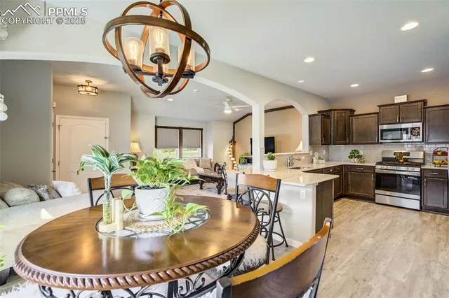 a view of a dining room with furniture and a chandelier